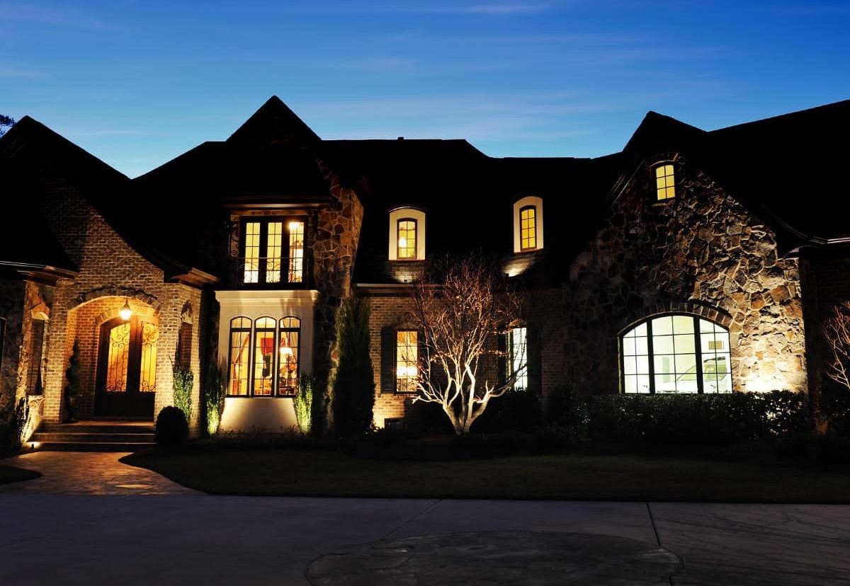 large luxury home at night with residential security